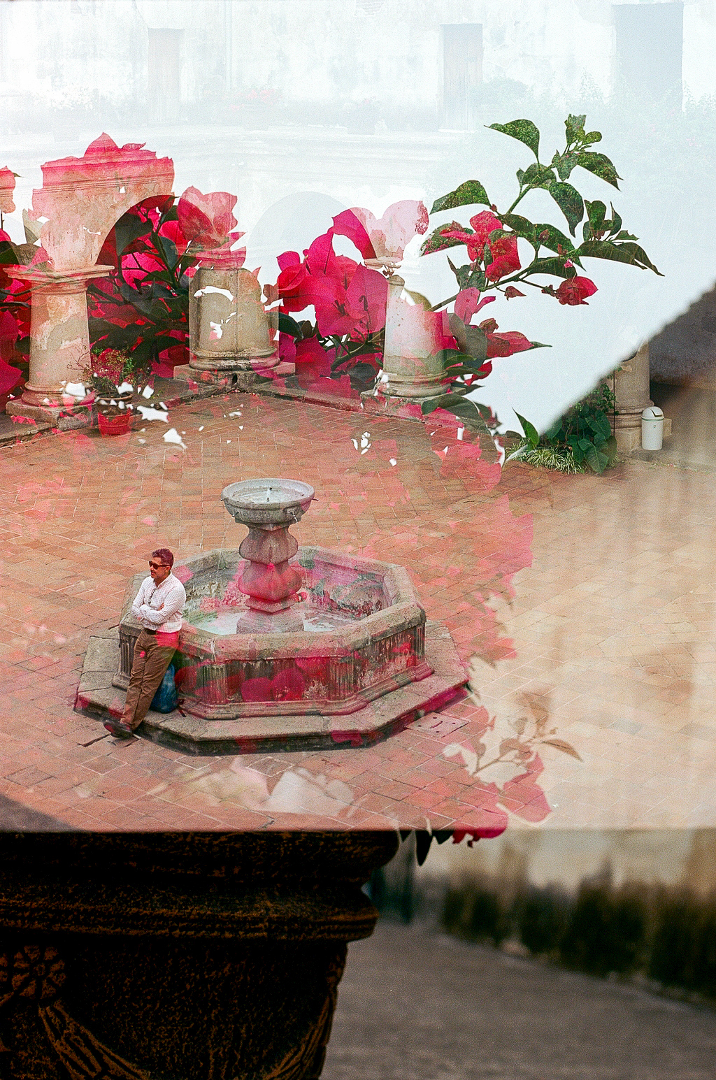 Double exposure of courtyard with fountain and bougainvillea flowers
