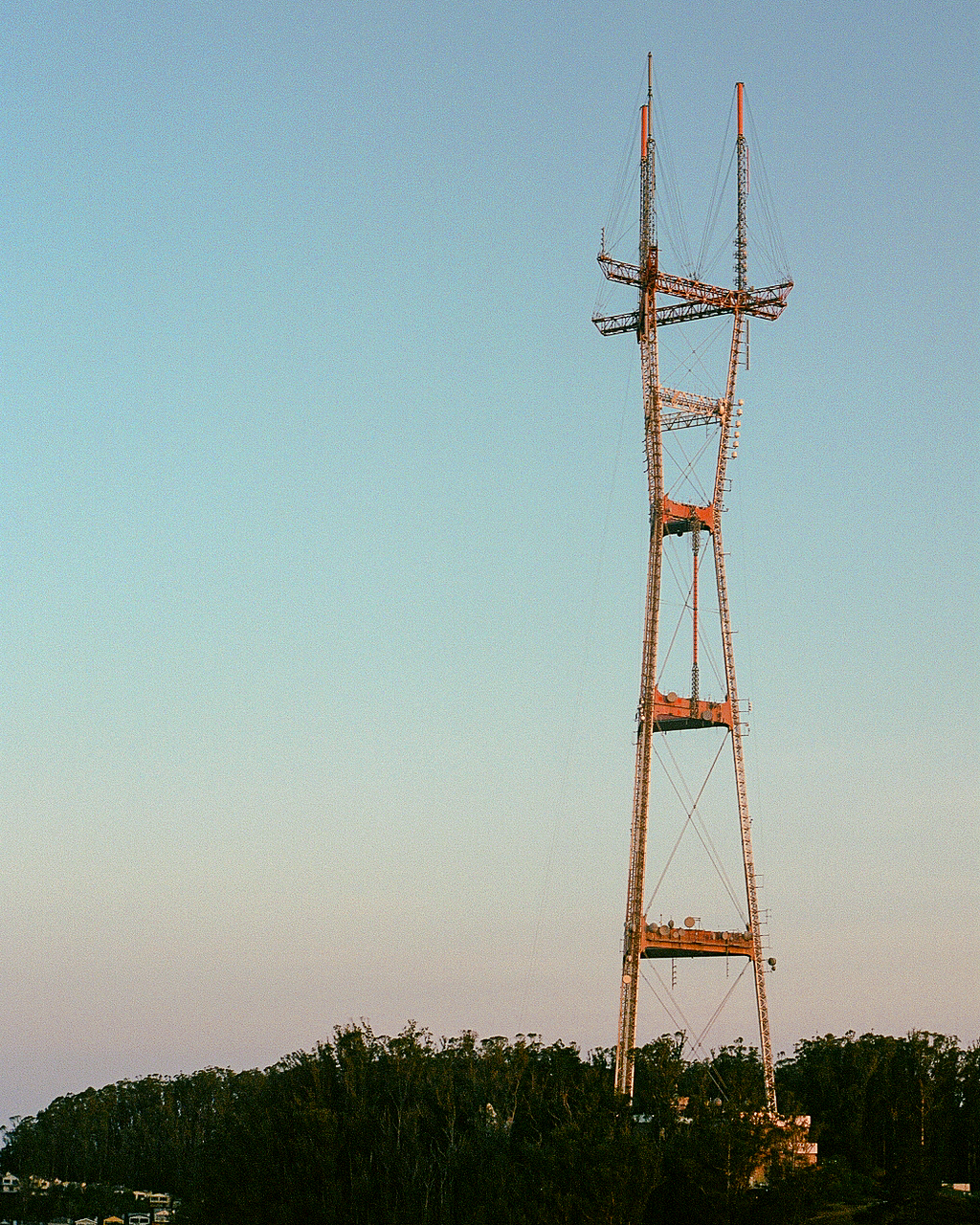 Tall radio tower against a gradient blue sky at sunset