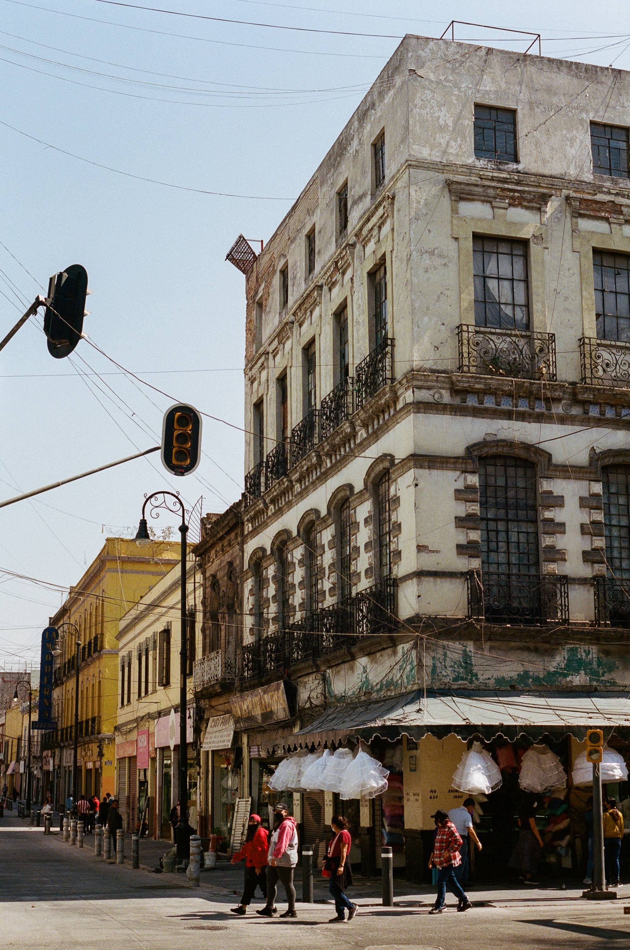 Colonial buildings in Latin American city with pedestrians walking by